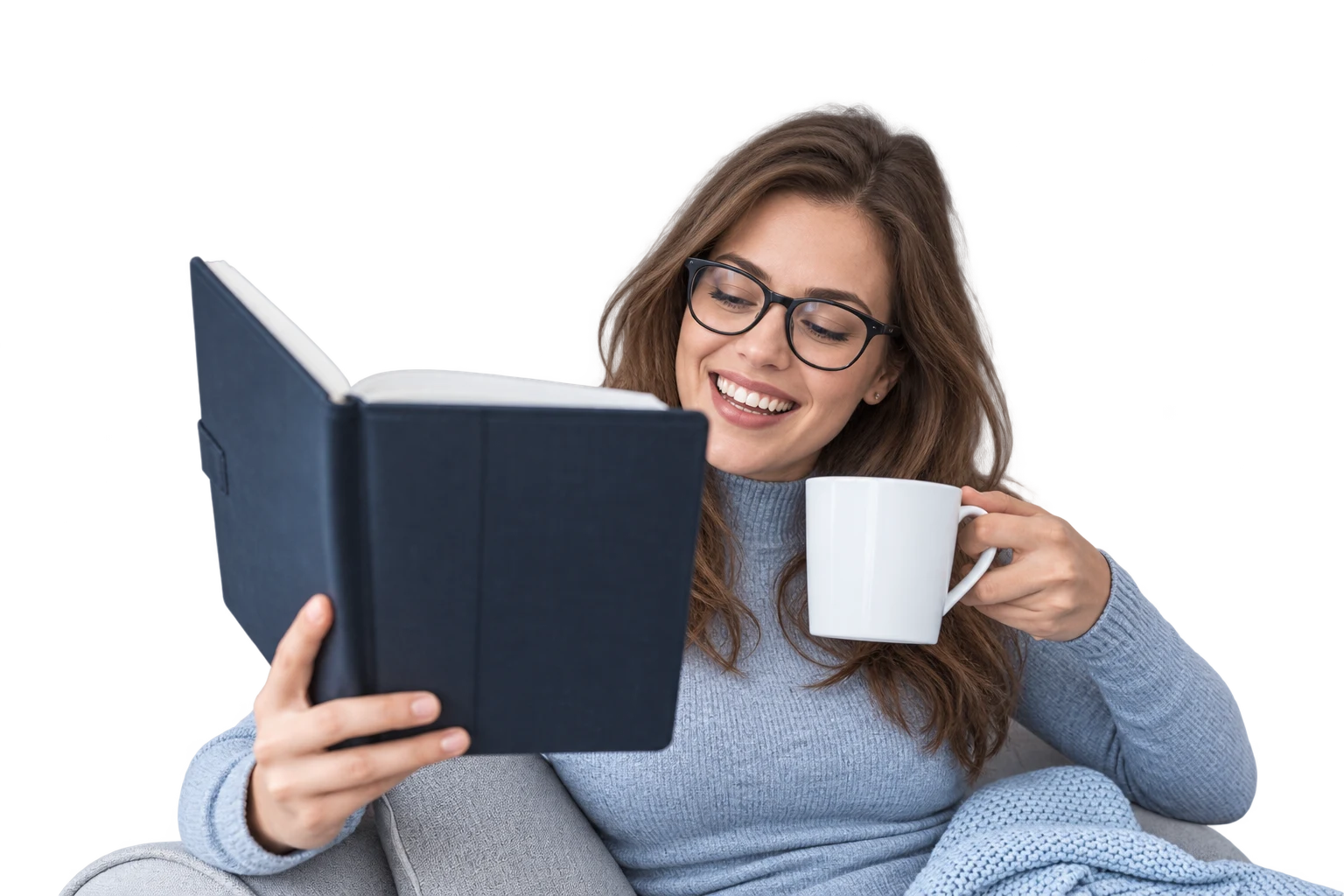Woman in glasses reading a book and holding a mug