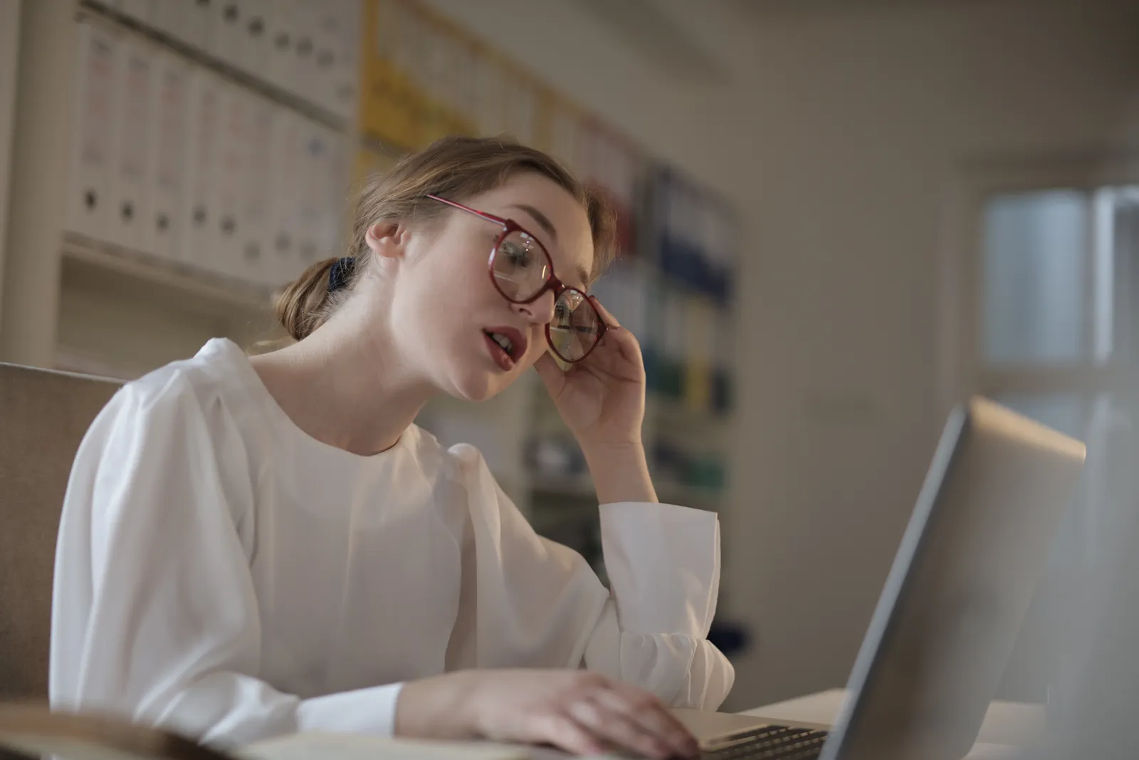 Woman working on a laptop in an office